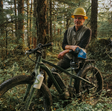 Board member Dave Haas sits on his bike on the Treadwell Ditch trail