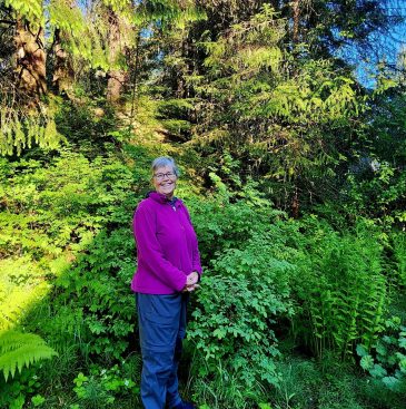 Board member Kim Kiefer standing in bush