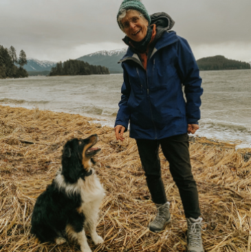 Board member Diane Mayer and her dog pose for a photo at Boy Scout beach.