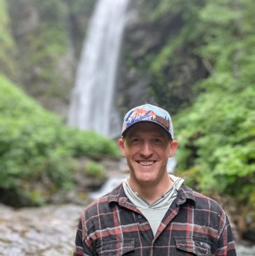 Trail Project Coordinator Mark Krumwiede Standing Near Waterfall